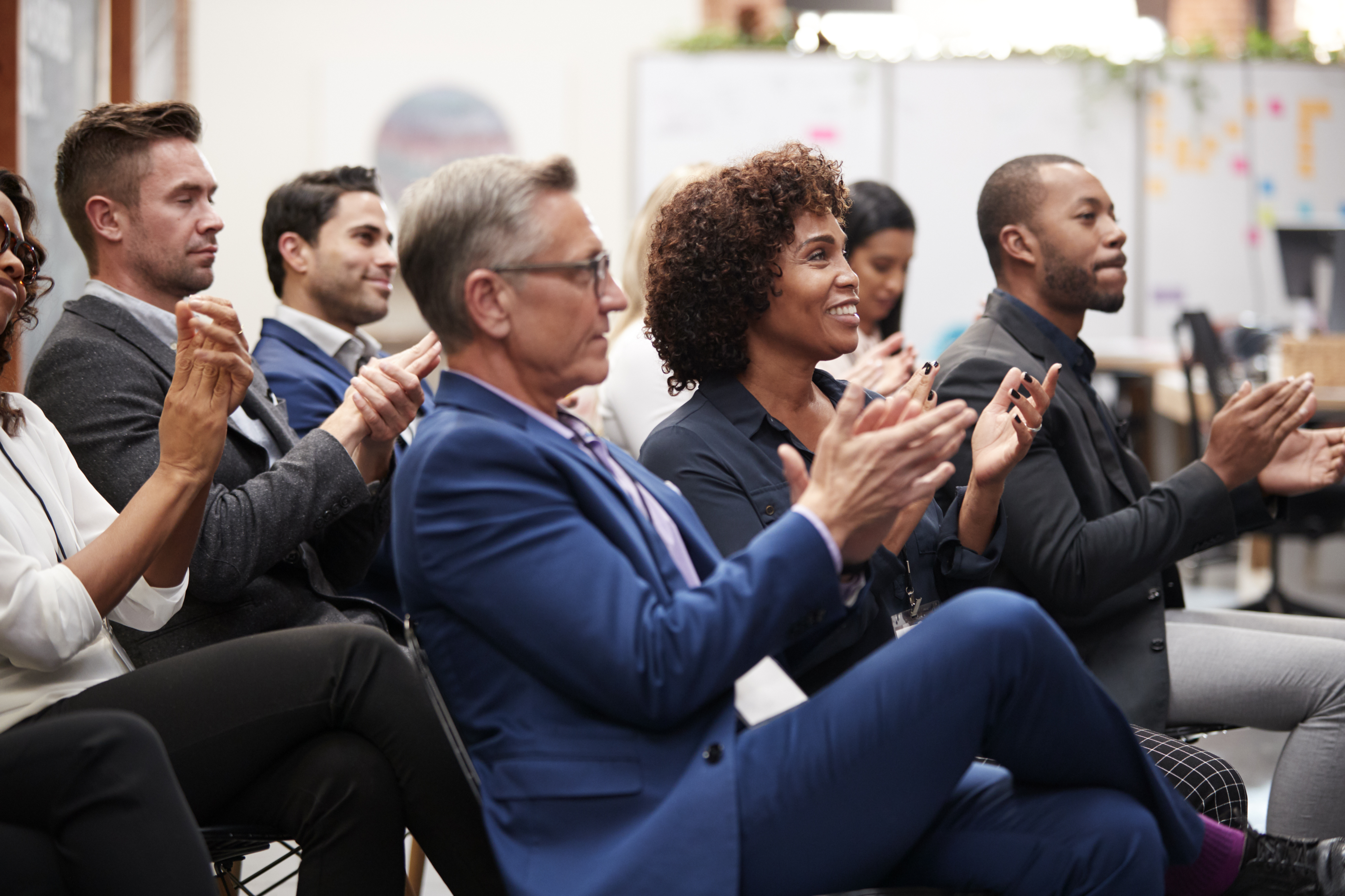 An engaged conference audience applauding a presentation